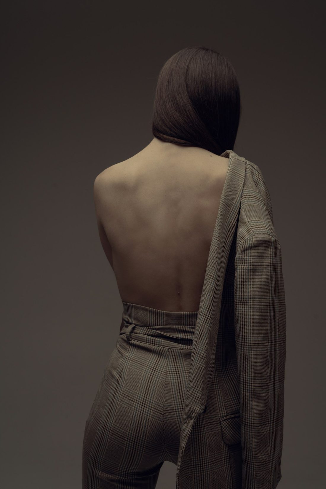 Draped fabric over a shoulder in warm low light