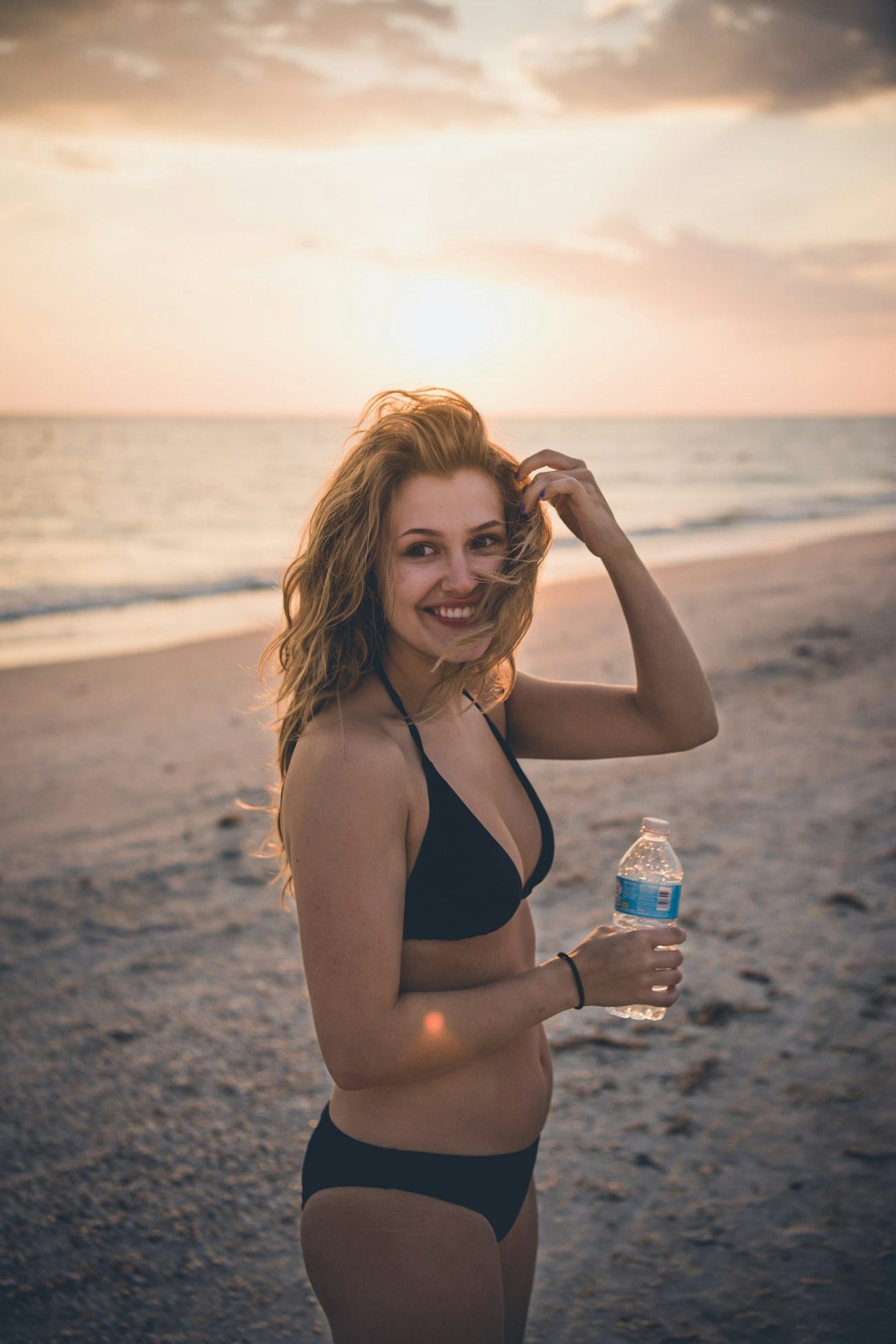 Woman on a Florida beach at golden hour with a warm sunless glow