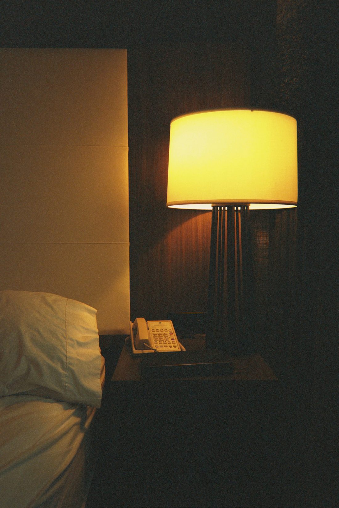 Warm lamplight in a hotel suite at night