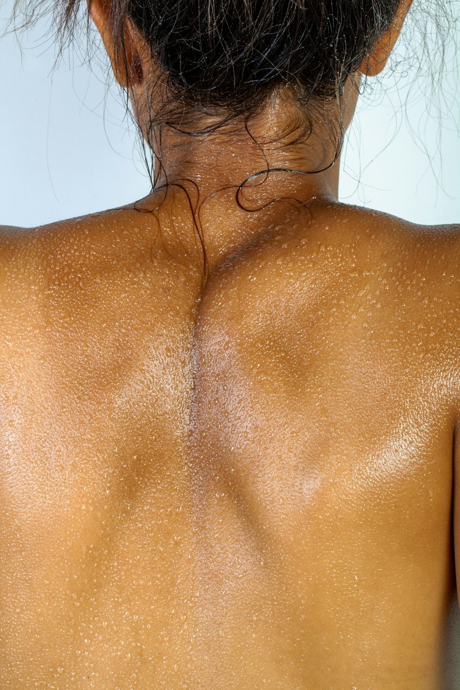 Close view of sun-warmed shoulders and back with an even bronzed tone
