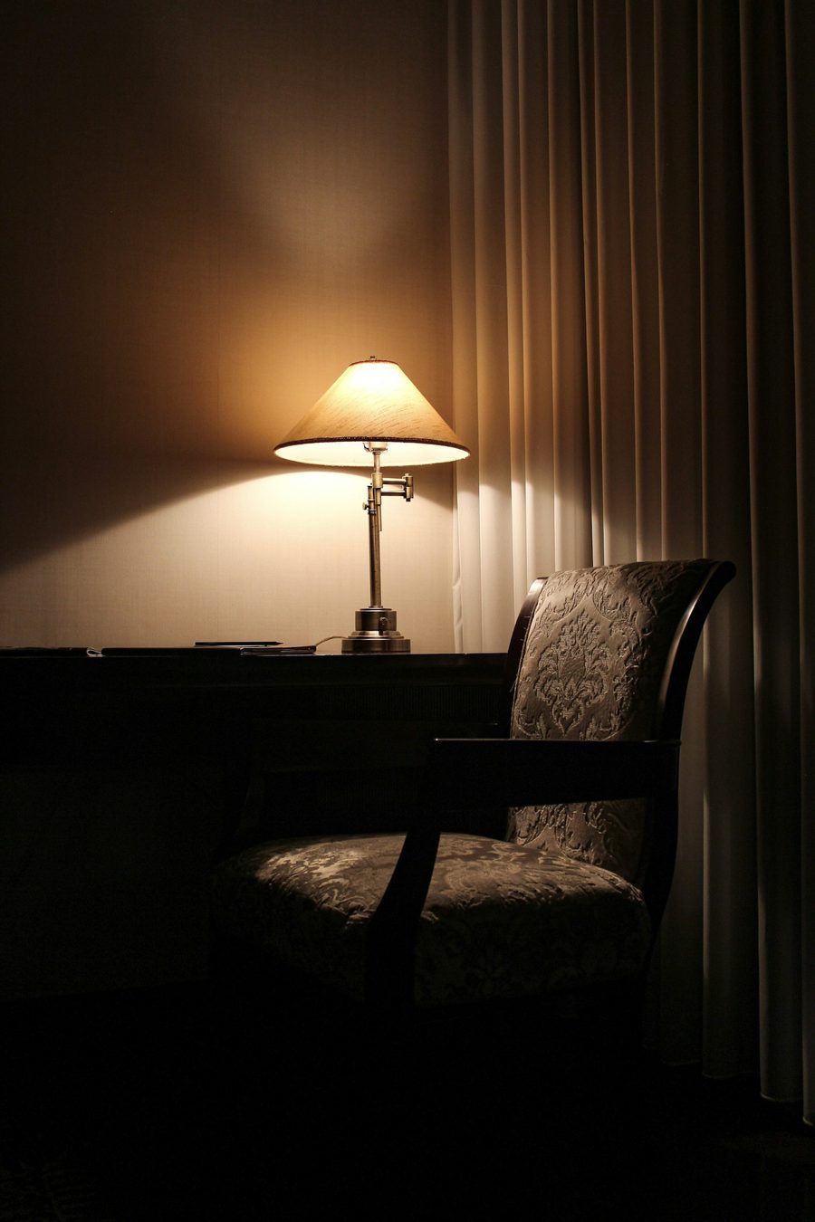 Warm lamplight in a quiet private suite at night